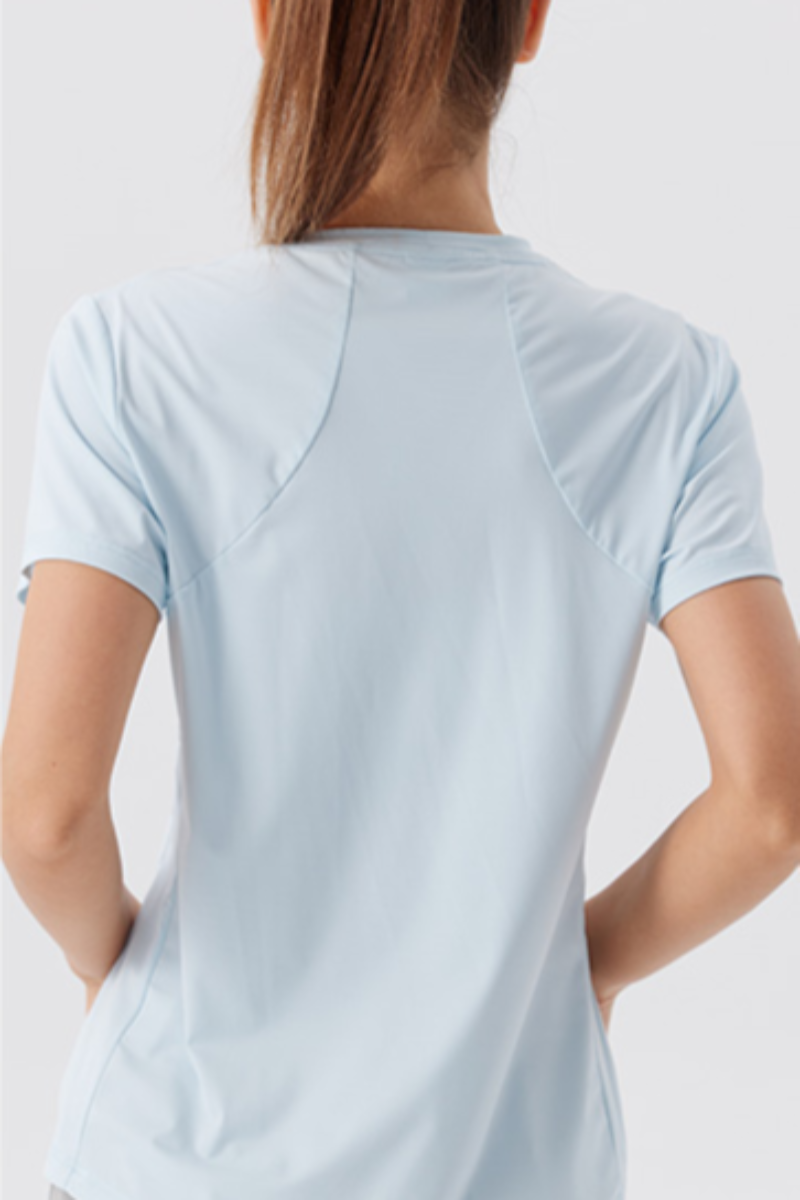 Woman wearing a light blue t-shirt with a backpack, shown from front and back views.